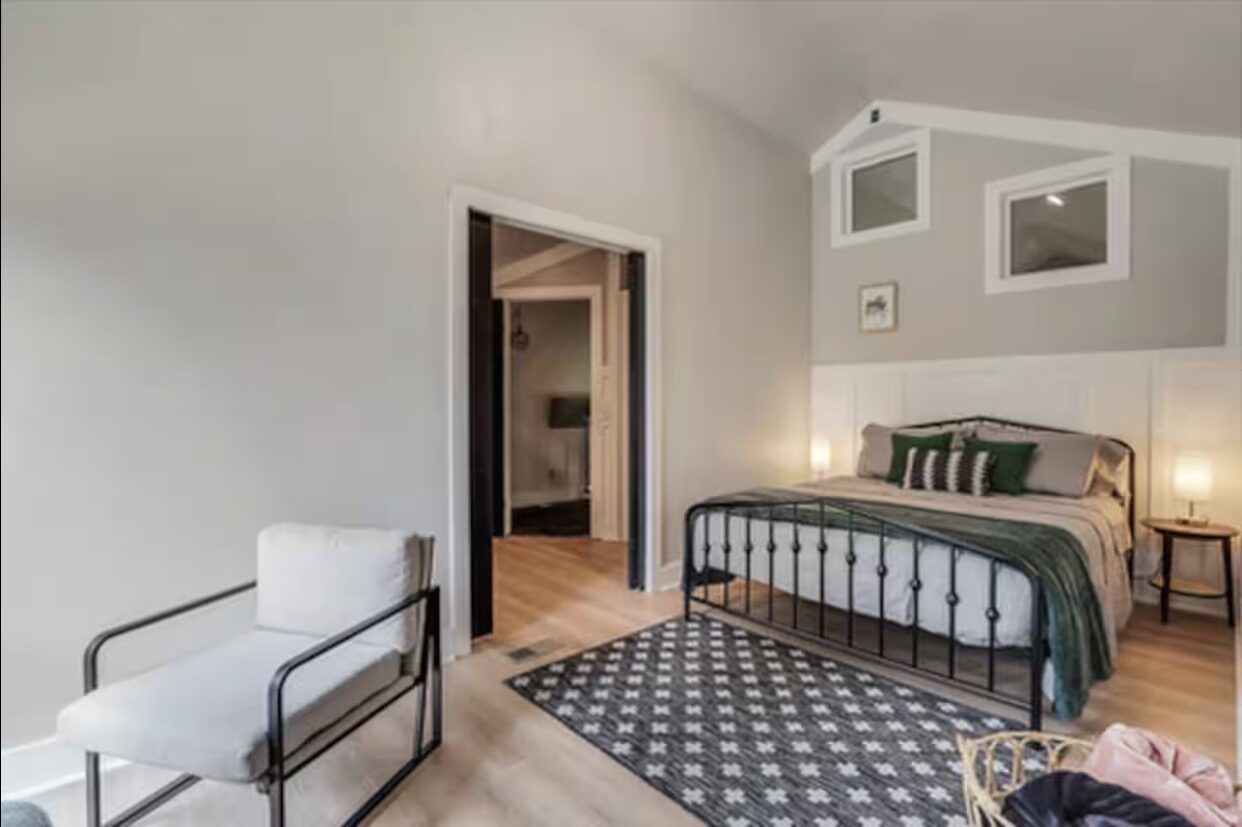 Upstairs bedroom with iron bed frame