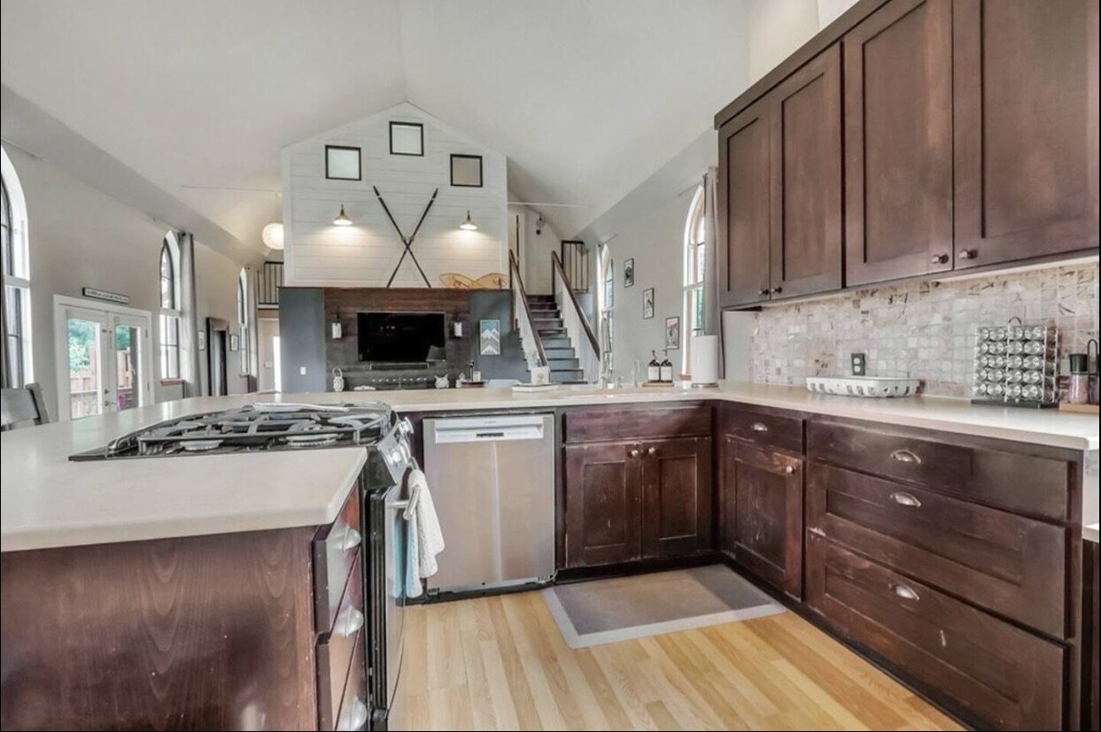 Kitchen with gas cooktop and arched church window